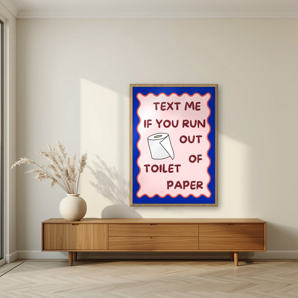 Text Me If You Run Out of Toilet Paper – Cobalt Blue art print, in an oak frame, styled in a living room