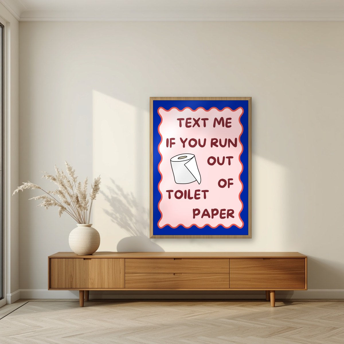 Text Me If You Run Out of Toilet Paper – Cobalt Blue art print, in an oak frame, styled in a living room