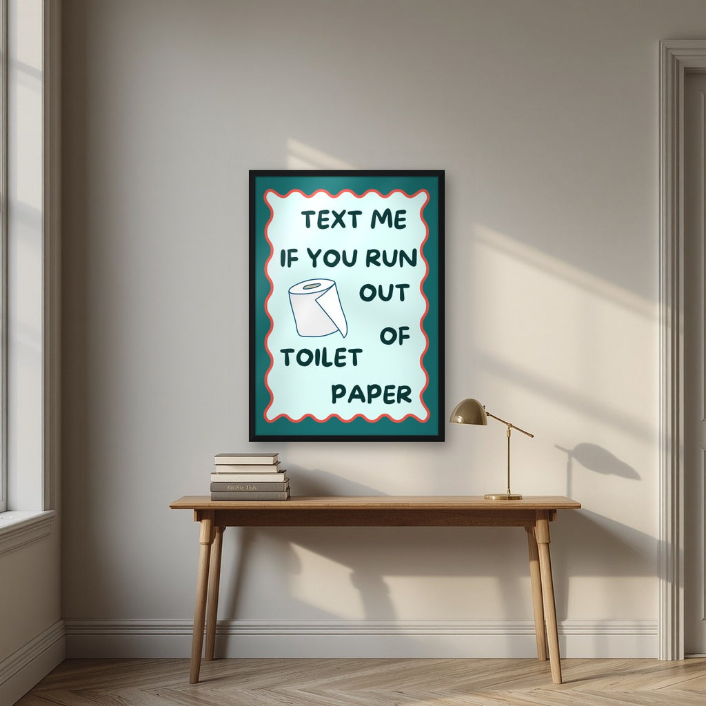 Text Me If You Run Out of Toilet Paper – Seafoam Teal art print, in a black frame, styled in a desk