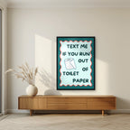 Text Me If You Run Out of Toilet Paper – Seafoam Teal art print, in a black frame, styled in a living room