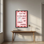 Text Me If You Run Out of Toilet Paper – Terracotta Stripe art print, in a black frame, styled in a desk