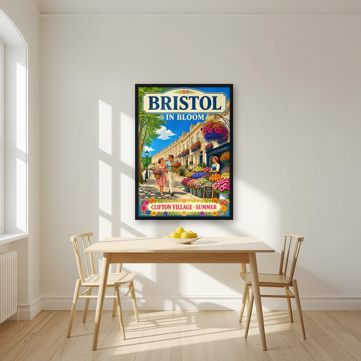 Clifton Village in a black frame, above a dining table in a bright kitchen