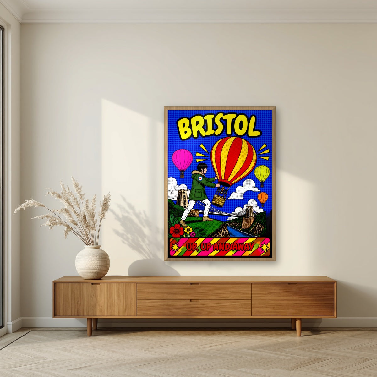 Up, Up and Away in an oak frame, above a walnut sideboard in a living room