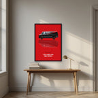 I Love It When a Plan Comes Together – Alarm Red art print, in a black frame, styled in a desk