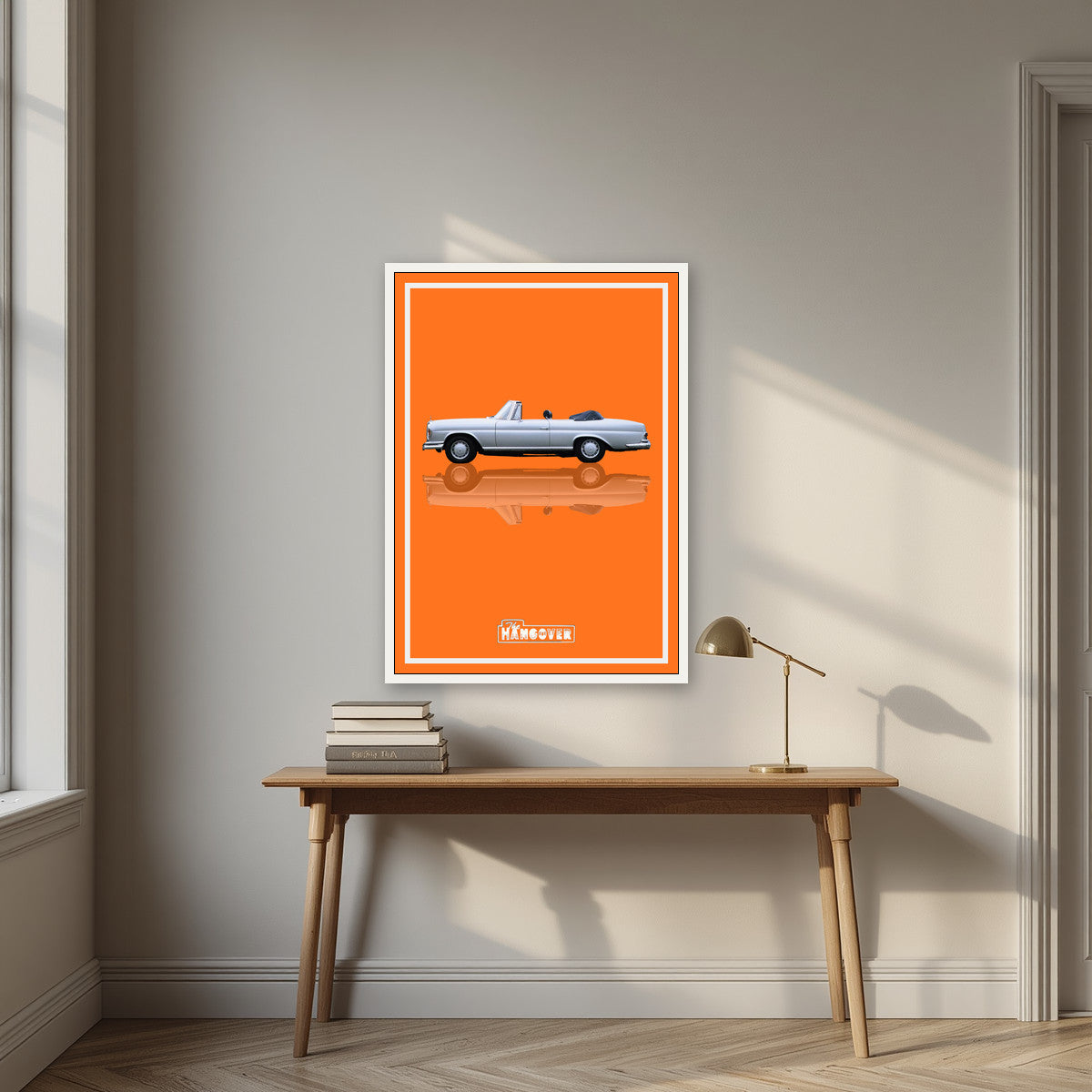 The Hangover – Desert Orange art print, in a white frame, styled in a desk