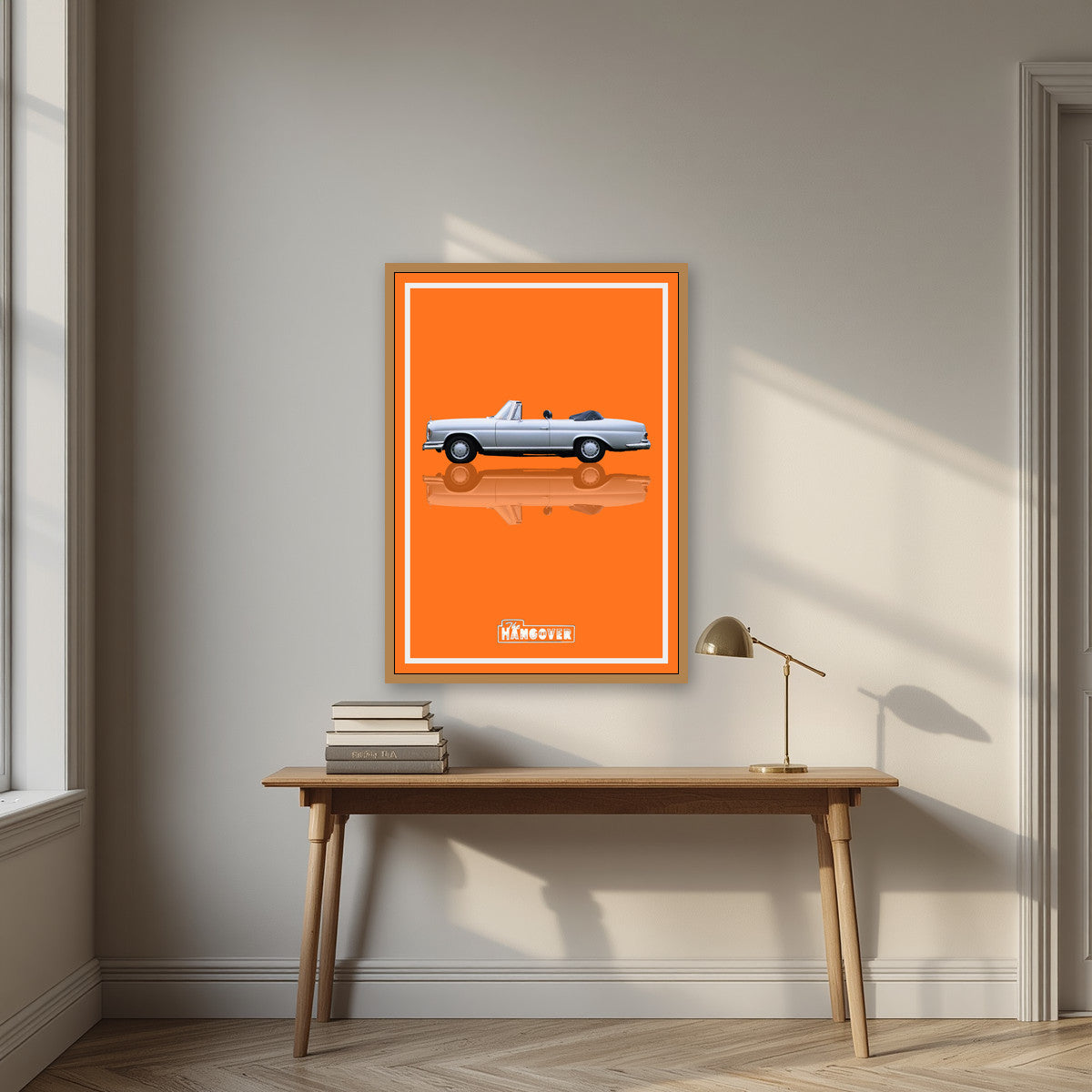 The Hangover – Desert Orange art print, in an oak frame, styled in a desk