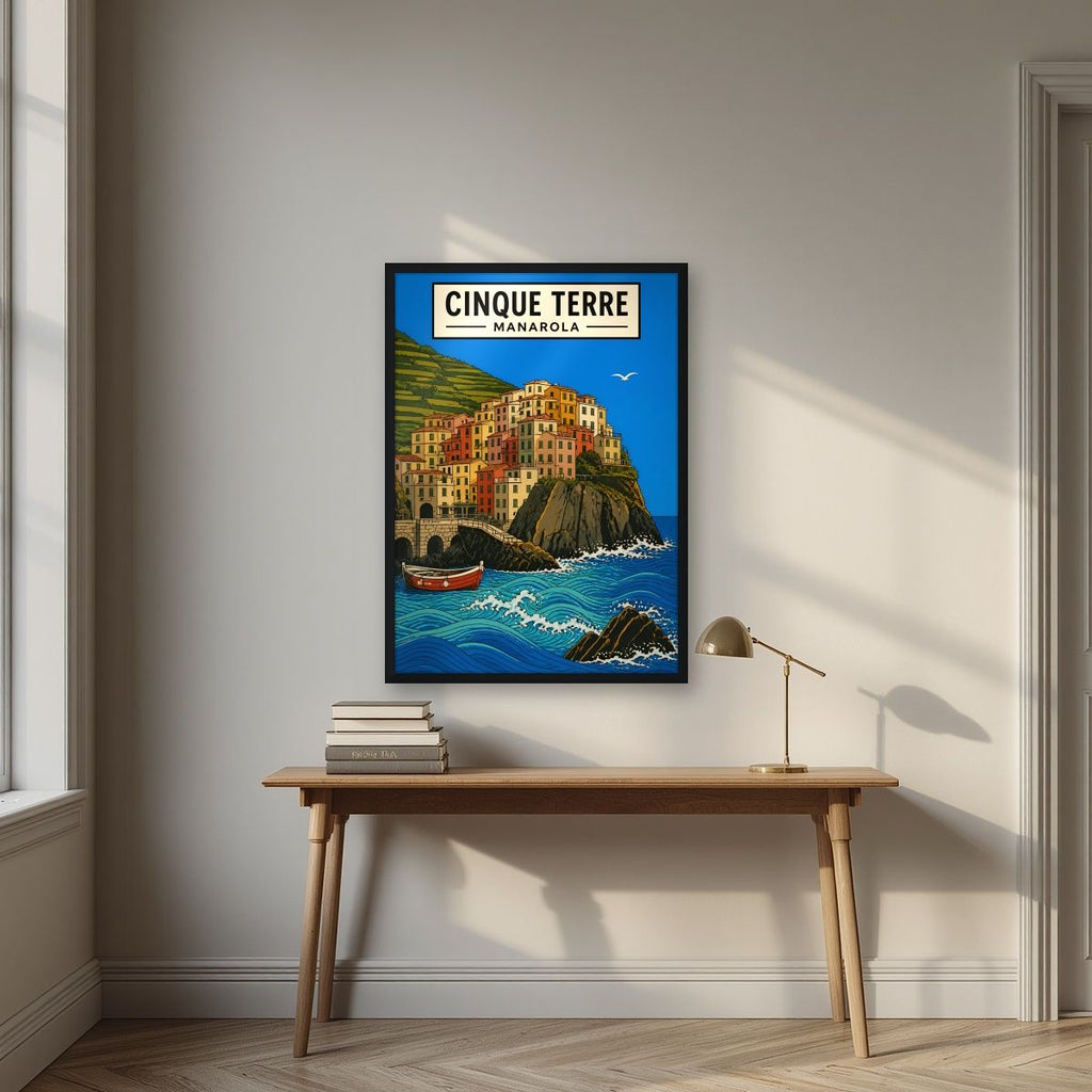 Manarola Blu — Cinque Terre art print, in a black frame, styled in a desk