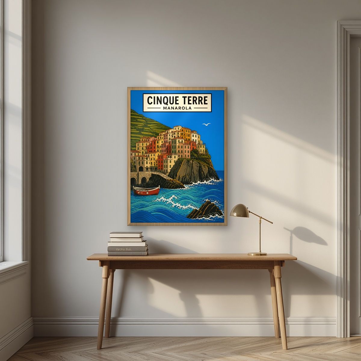 Manarola Blu — Cinque Terre art print, in an oak frame, styled in a desk