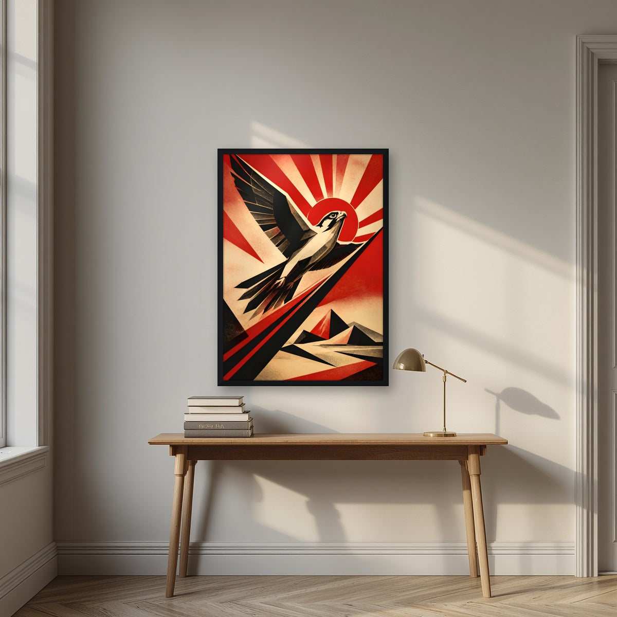 Falcon Rising in a black frame, above an oak writing desk