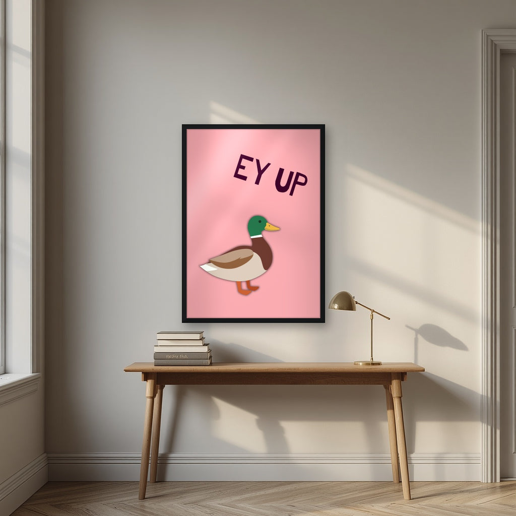 Ey Up Duck – Candyfloss Pink art print in a black frame, styled above a desk