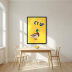 Ey Up Duck – Custard Gold art print in a black frame, styled in a kitchen