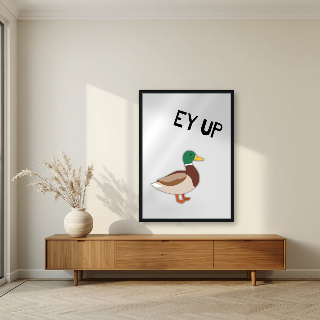 Ey Up Duck – Drizzle Grey art print in a black frame, styled in a living room