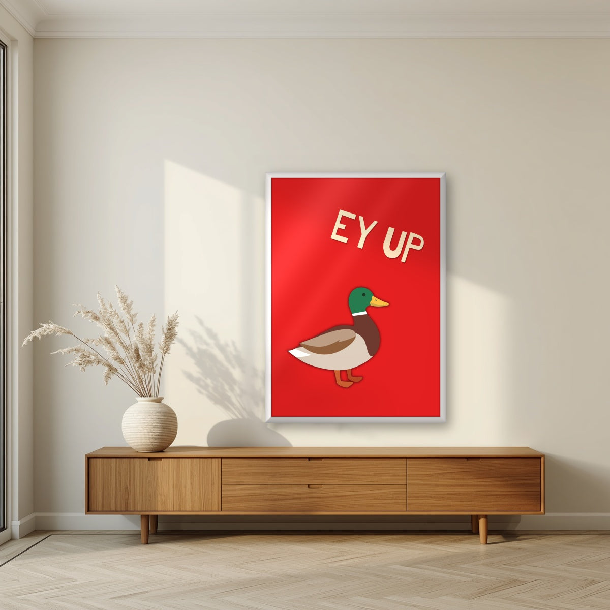 Ey Up Duck – Postbox Red art print in a white frame, styled in a living room