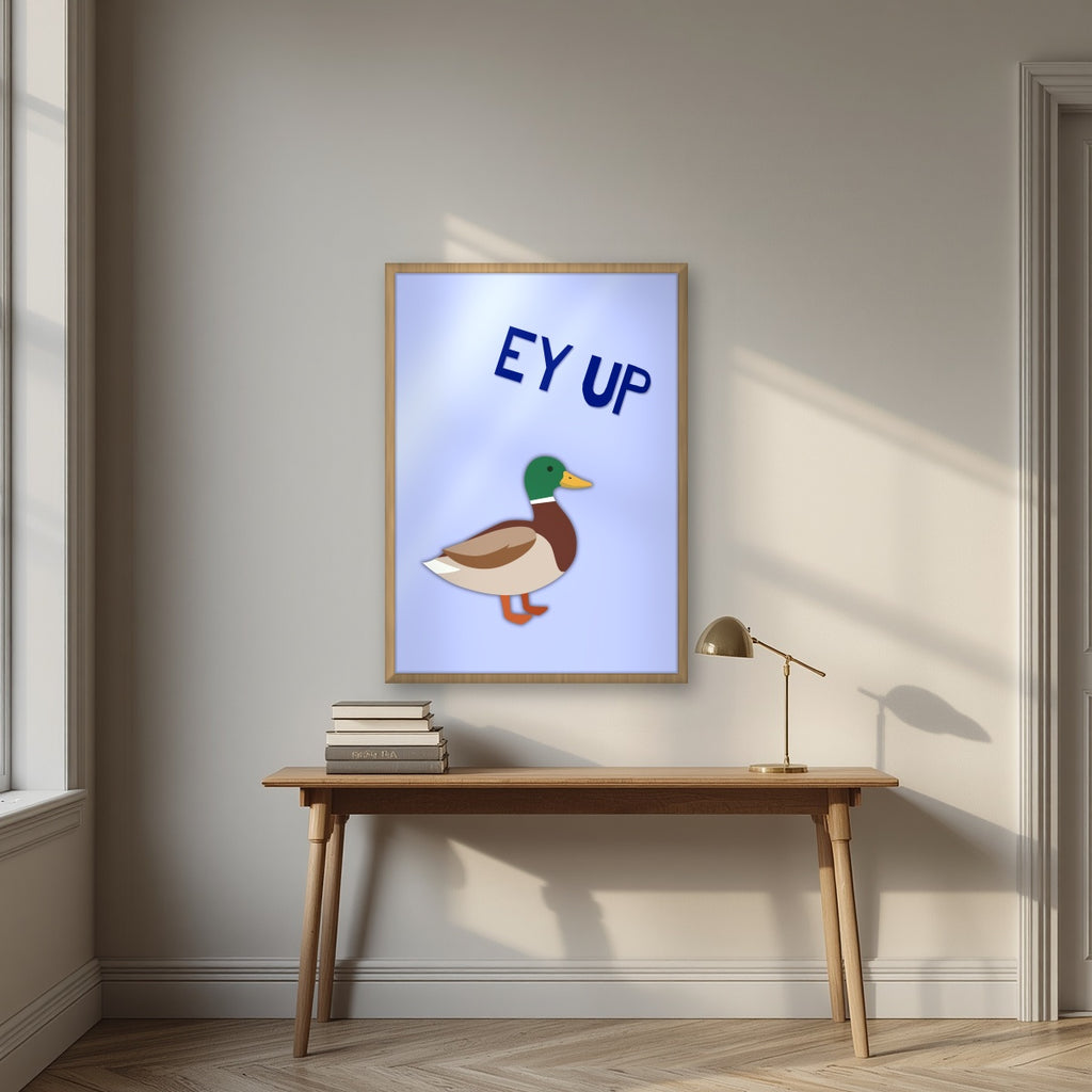 Ey Up Duck – Powder Blue art print in an oak frame, styled above a desk