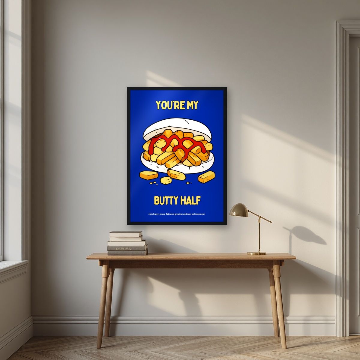 You're My Butty Half – Deckchair Blue art print, in a black frame, styled in a desk