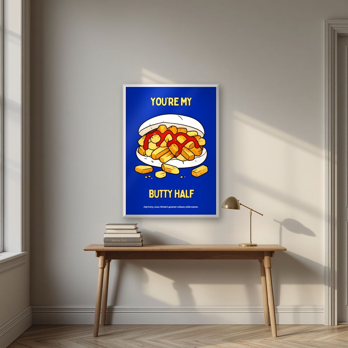 You're My Butty Half – Deckchair Blue art print, in a white frame, styled in a desk