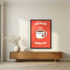 You're My Cuppa Tea – Postbox Coral art print, in a black frame, styled in a living room