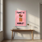 Fancy a Nibble – Candyfloss Pink art print, in a white frame, styled in a desk
