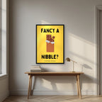 Fancy a Nibble – Chippy Gold art print, in a black frame, styled in a desk