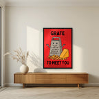 Grate to Meet You – Postbox Red art print, in a black frame, styled in a living room