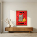 Grate to Meet You – Postbox Red art print, in an oak frame, styled in a living room