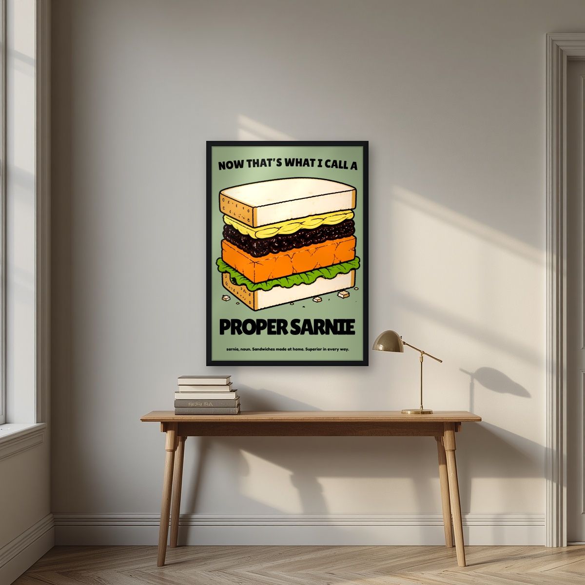 Now That's What I Call a Proper Sarnie – Allotment Sage art print, in a black frame, styled in a desk