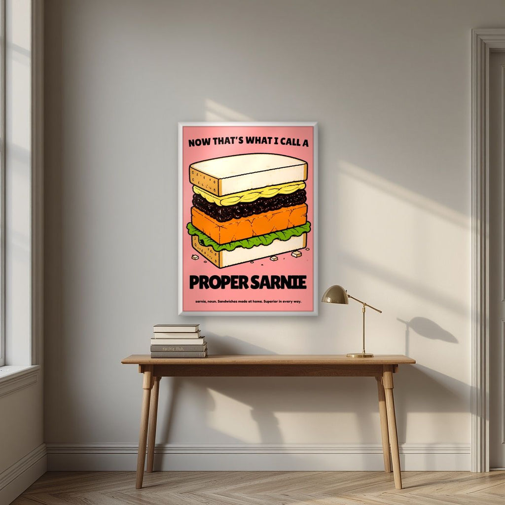 Now That's What I Call a Proper Sarnie – Battenberg Pink art print, in a white frame, styled in a desk