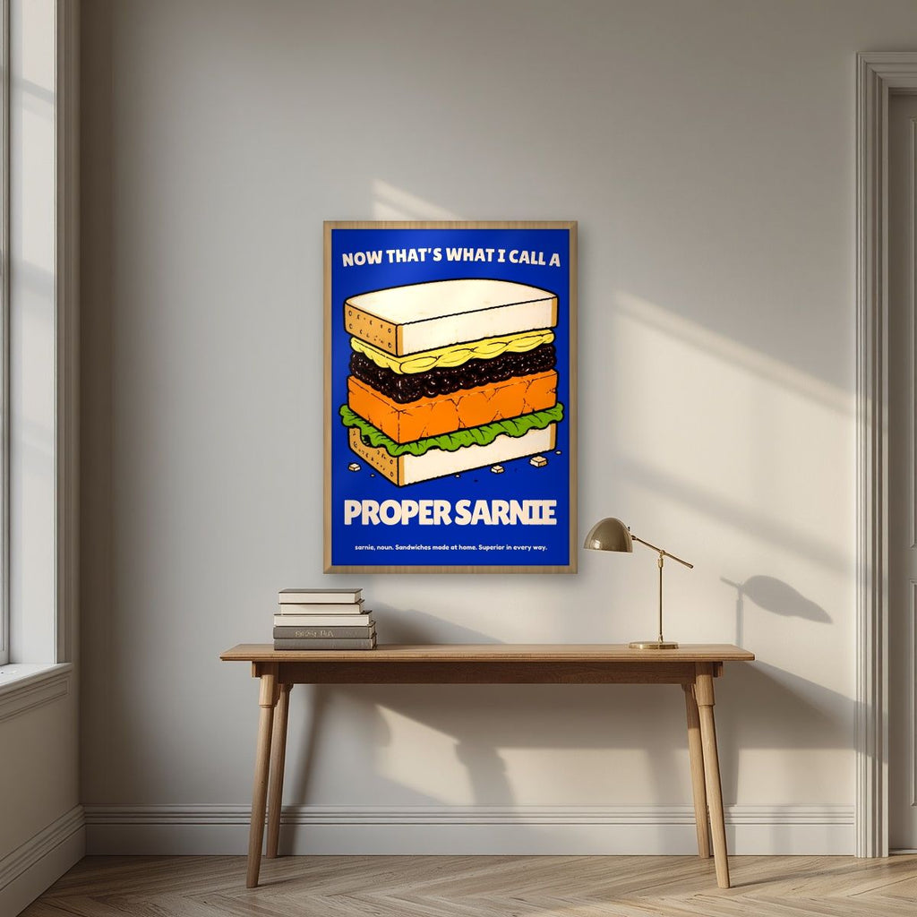 Now That's What I Call a Proper Sarnie – Deckchair Navy art print, in an oak frame, styled in a desk