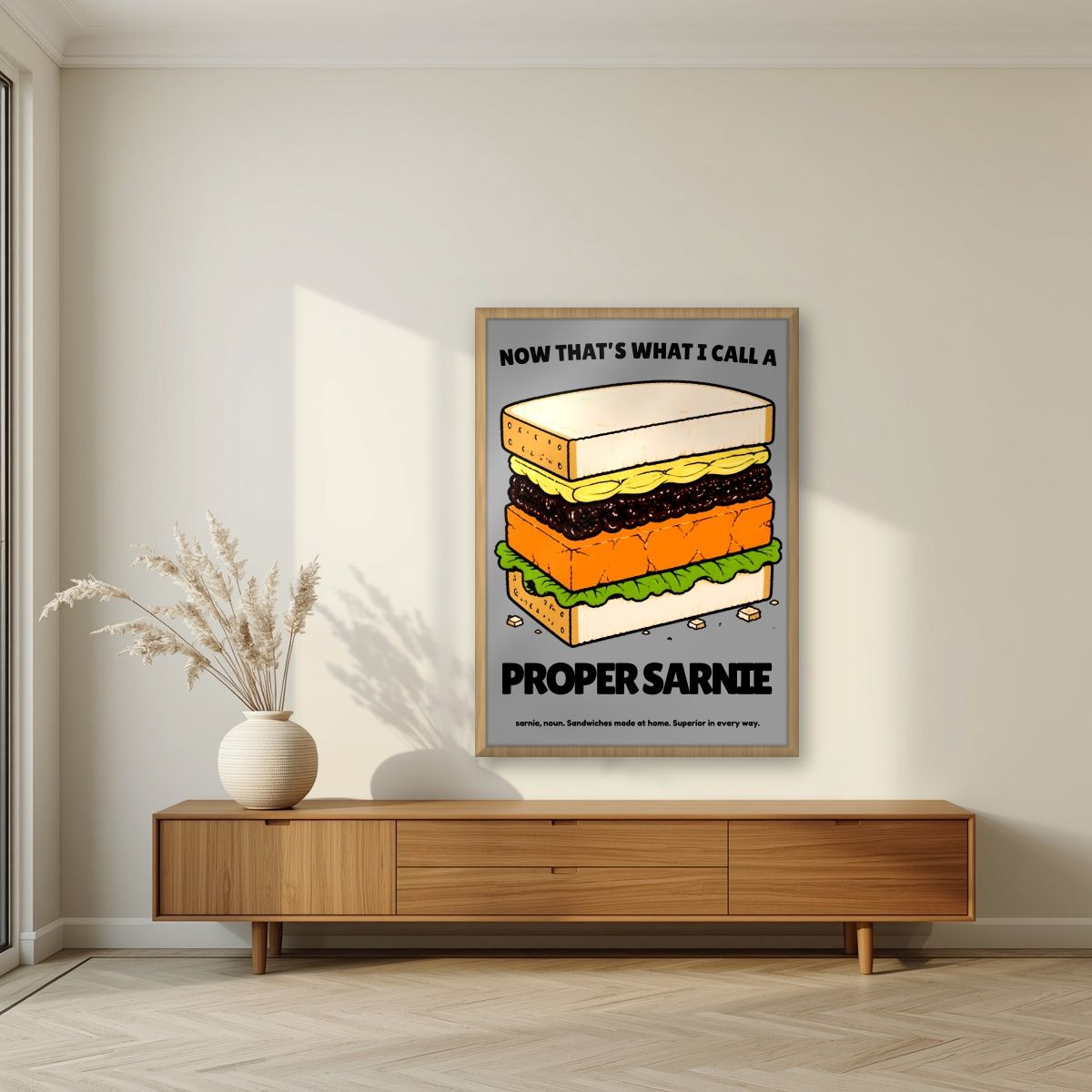 Now That's What I Call a Proper Sarnie – Drizzle Grey art print, in an oak frame, styled in a living room