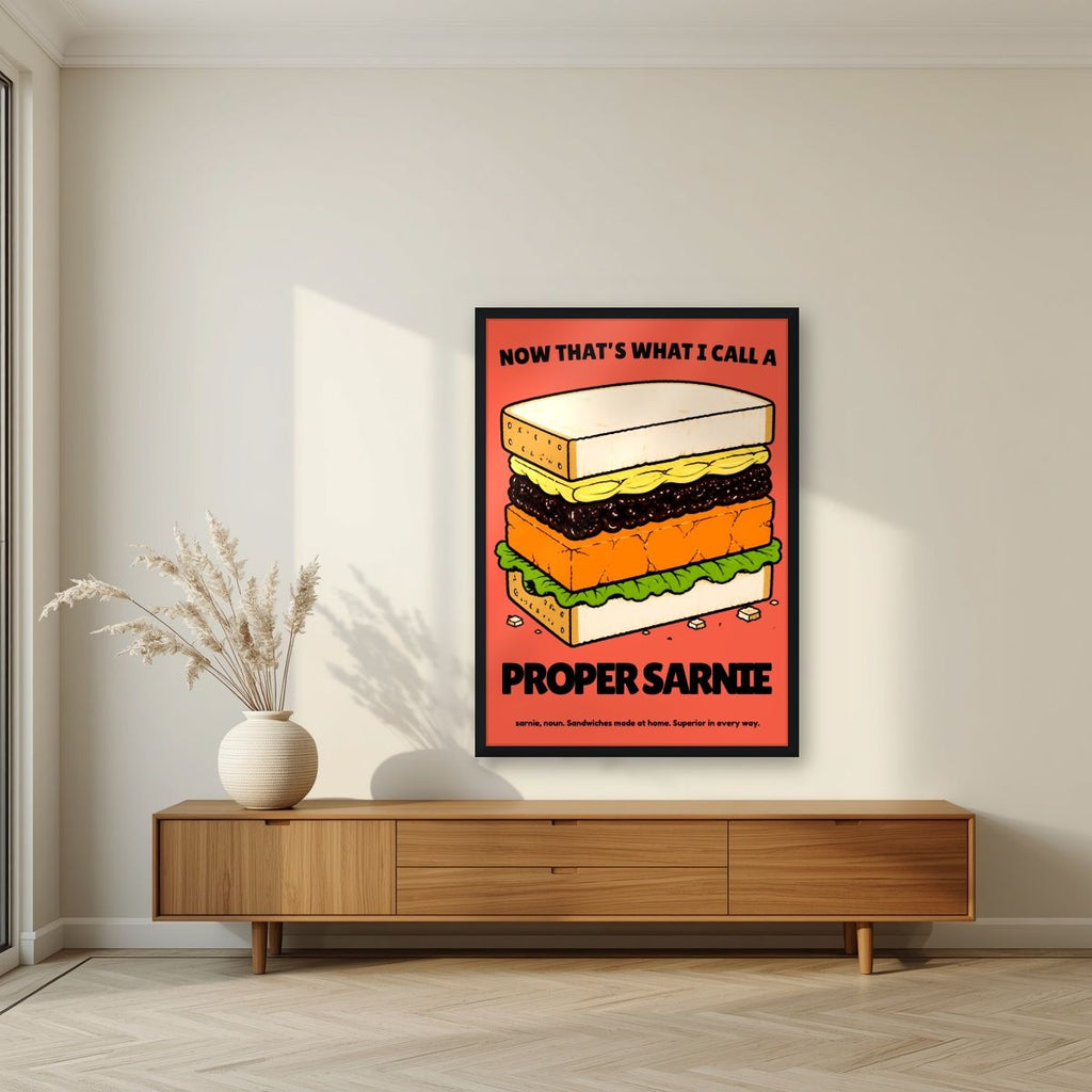 Now That's What I Call a Proper Sarnie – Ketchup Coral art print, in a black frame, styled in a living room