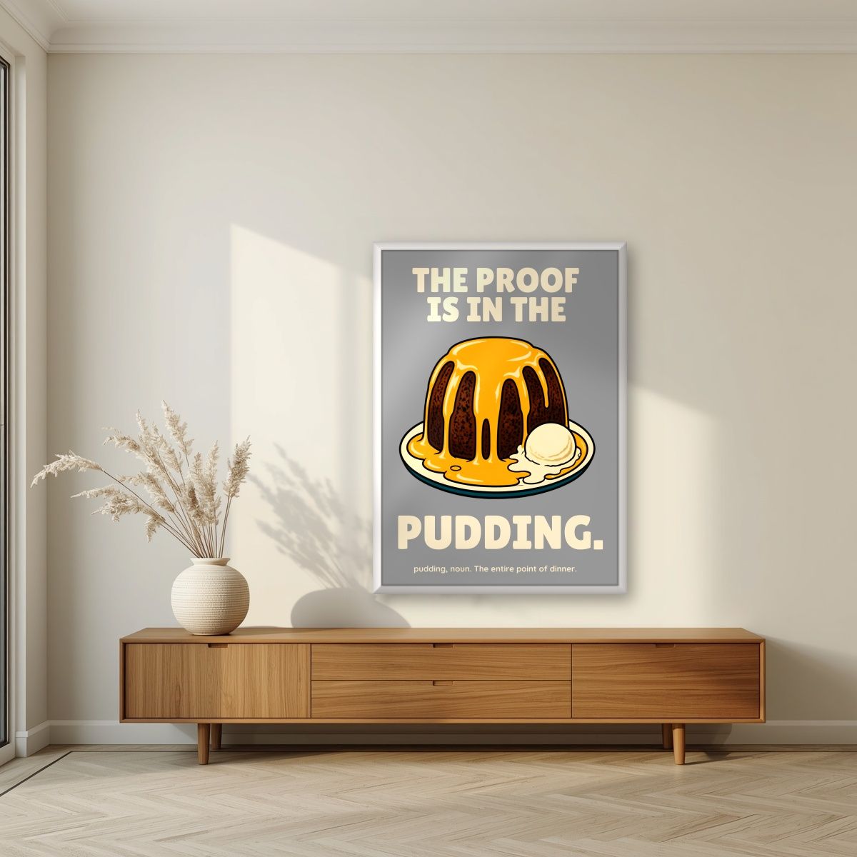 The Proof Is In The Pudding – Cobblestone Grey art print, in a white frame, styled in a living room