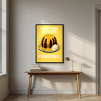 The Proof Is In The Pudding – Custard Gold art print, in a black frame, styled in a desk