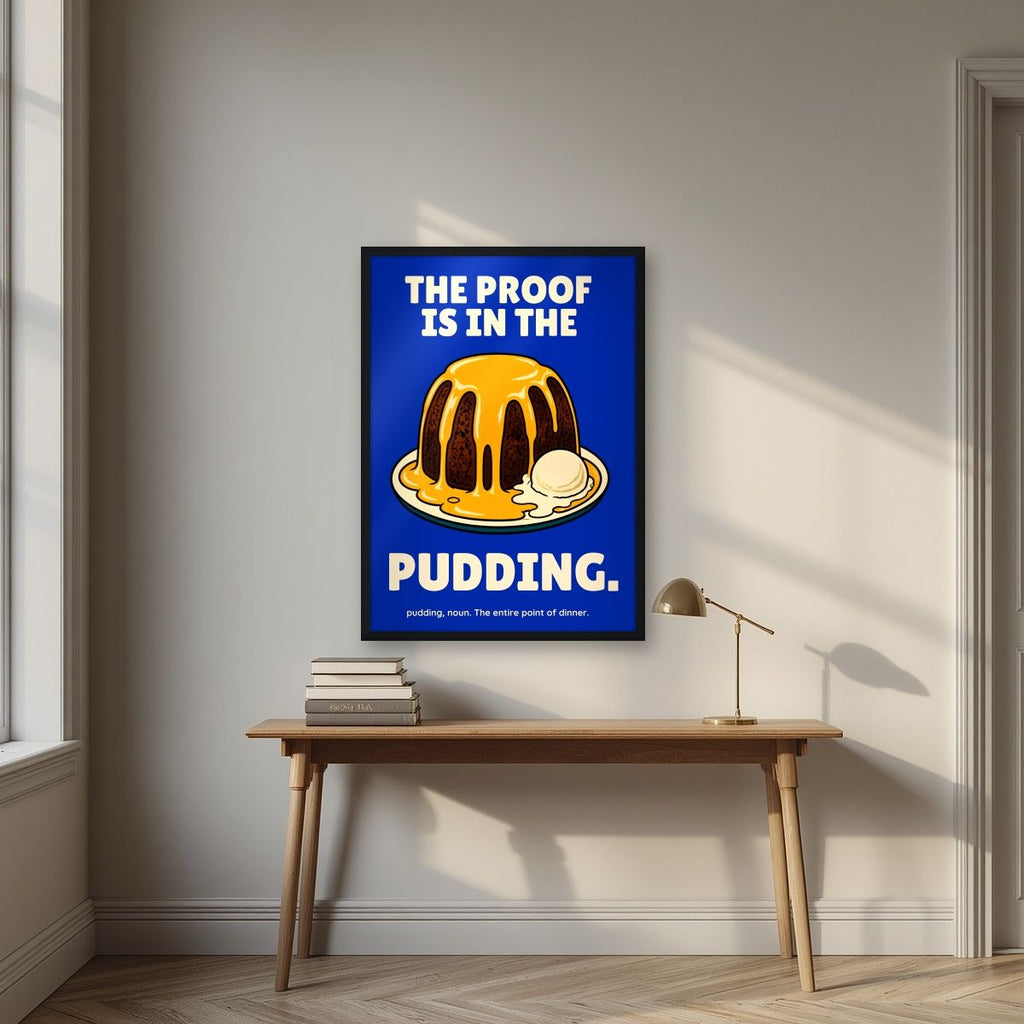 The Proof Is In The Pudding – Inkwell Blue art print, in a black frame, styled in a desk