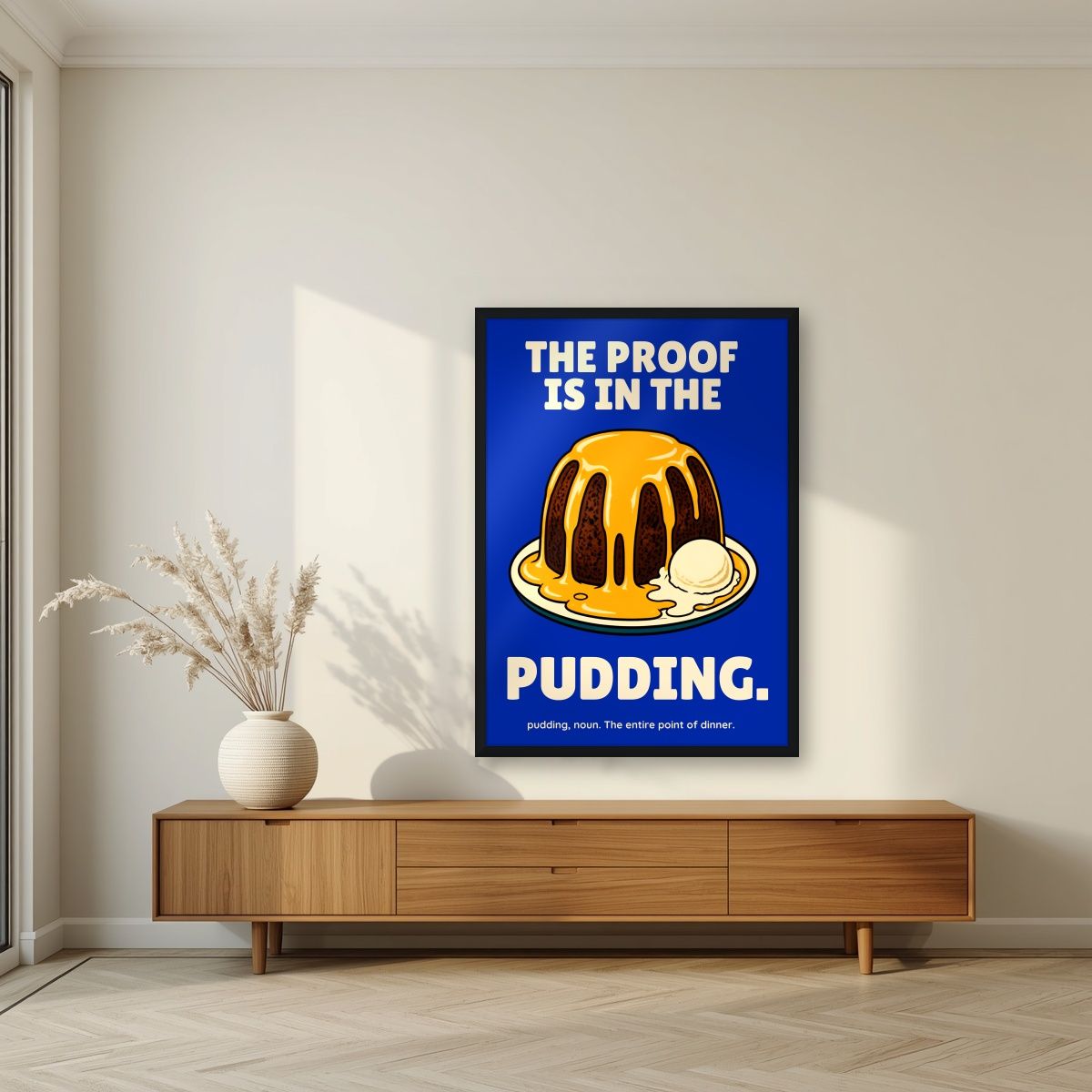 The Proof Is In The Pudding – Inkwell Blue art print, in a black frame, styled in a living room
