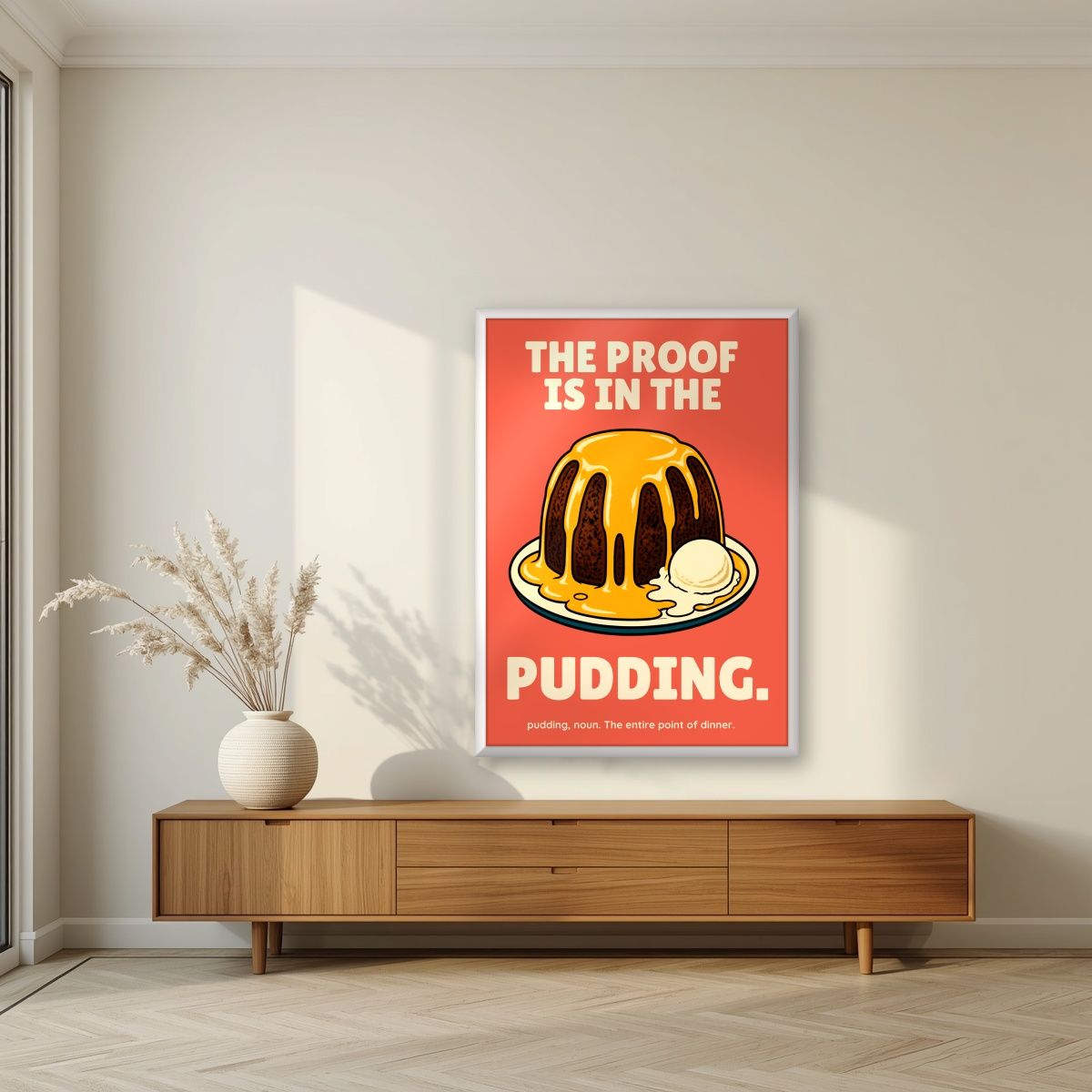 The Proof Is In The Pudding – Sunset Coral art print, in a white frame, styled in a living room