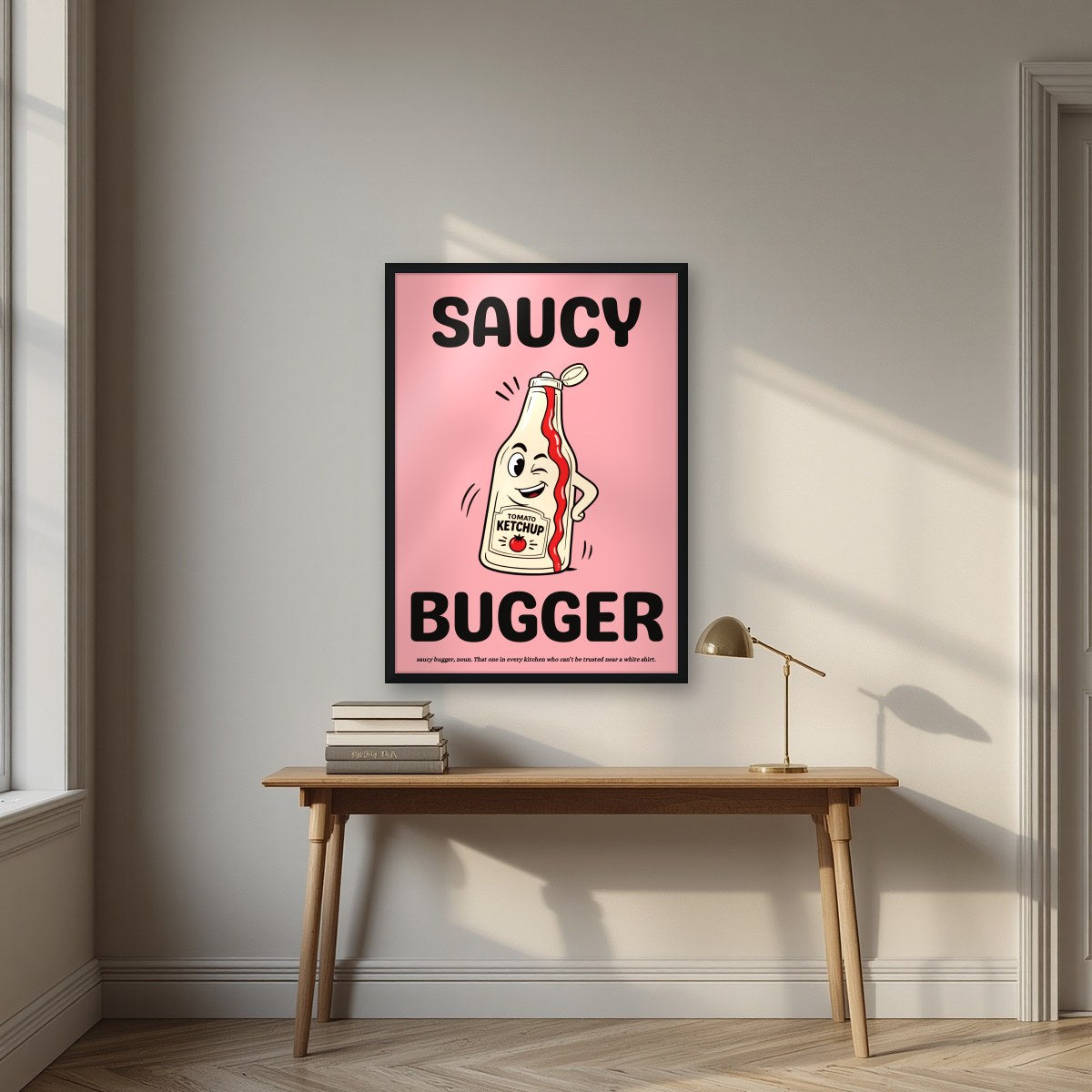 Saucy Bugger – Candyfloss Pink art print, in a black frame, styled in a desk
