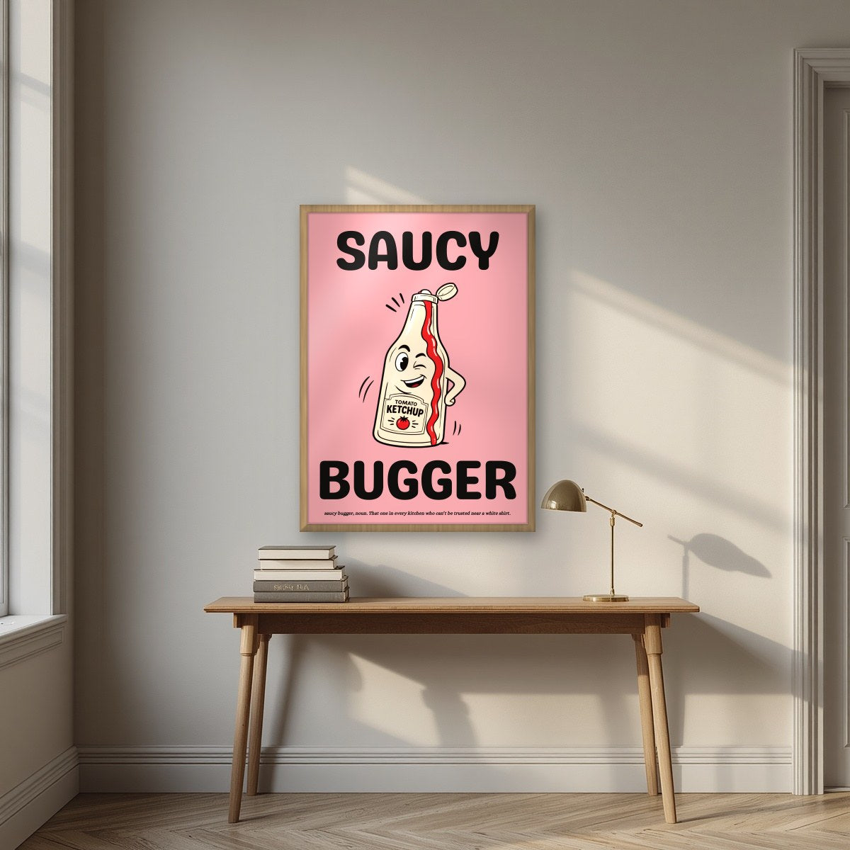 Saucy Bugger – Candyfloss Pink art print, in an oak frame, styled in a desk