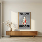 Saucy Bugger – Pebble Grey art print, in an oak frame, styled in a living room