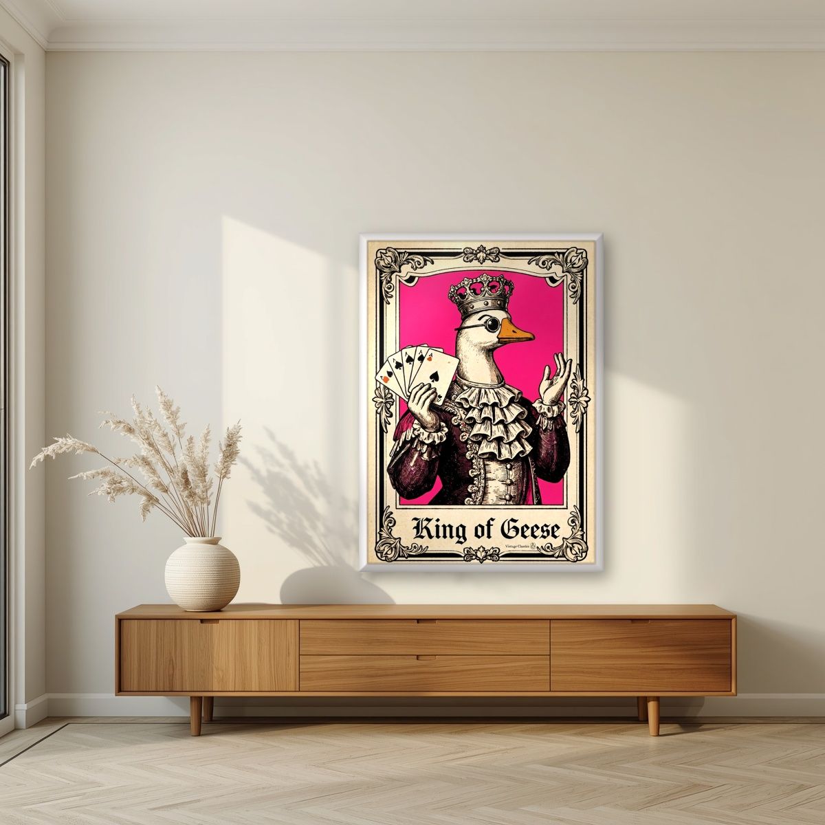 King of Geese – Jester Pink art print, in a white frame, styled in a living room