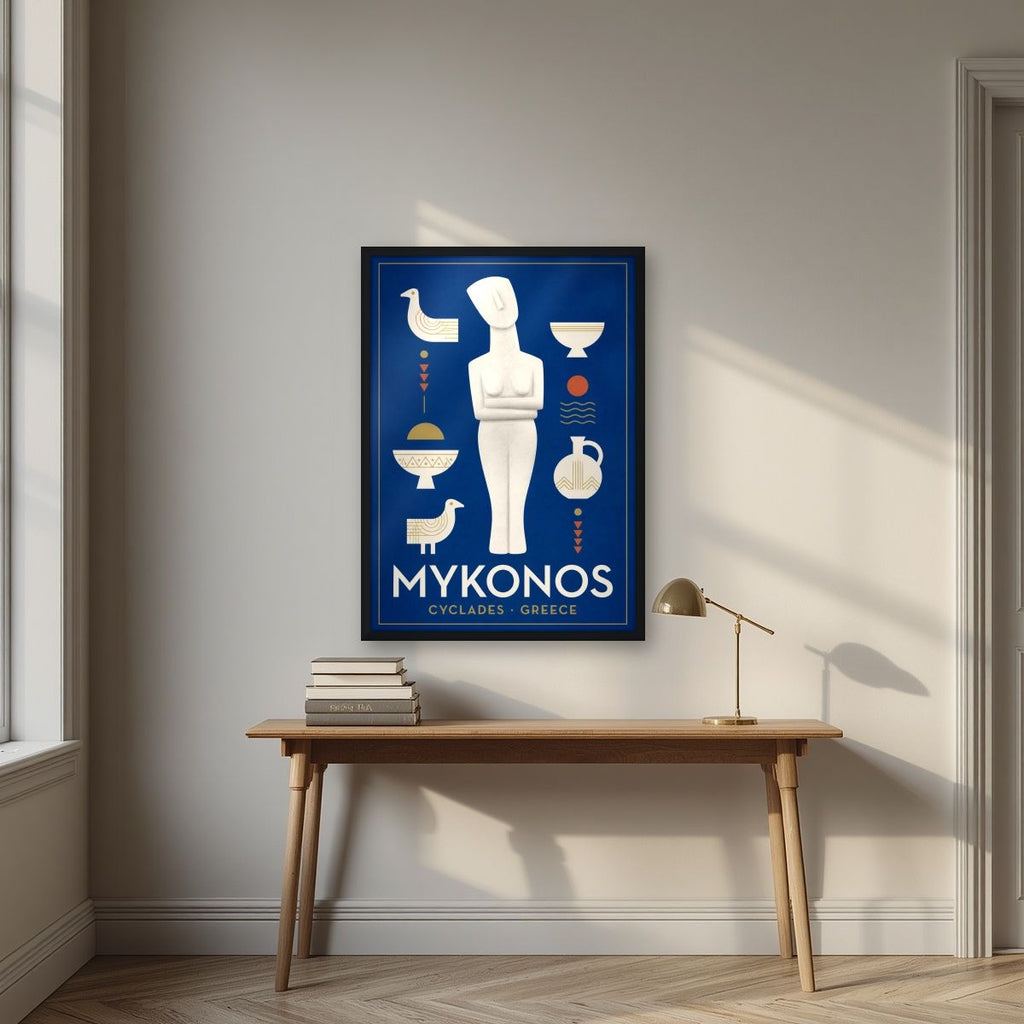 Kykladiki Morfi — Mykonos art print, in a black frame, styled in a desk