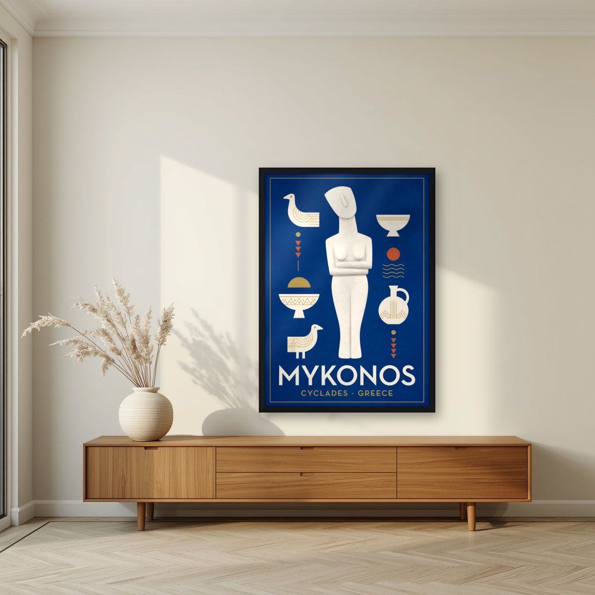 Kykladiki Morfi — Mykonos art print, in a black frame, styled in a living room