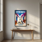Petros o Pelekanos — Mykonos art print, in a black frame, styled in a desk