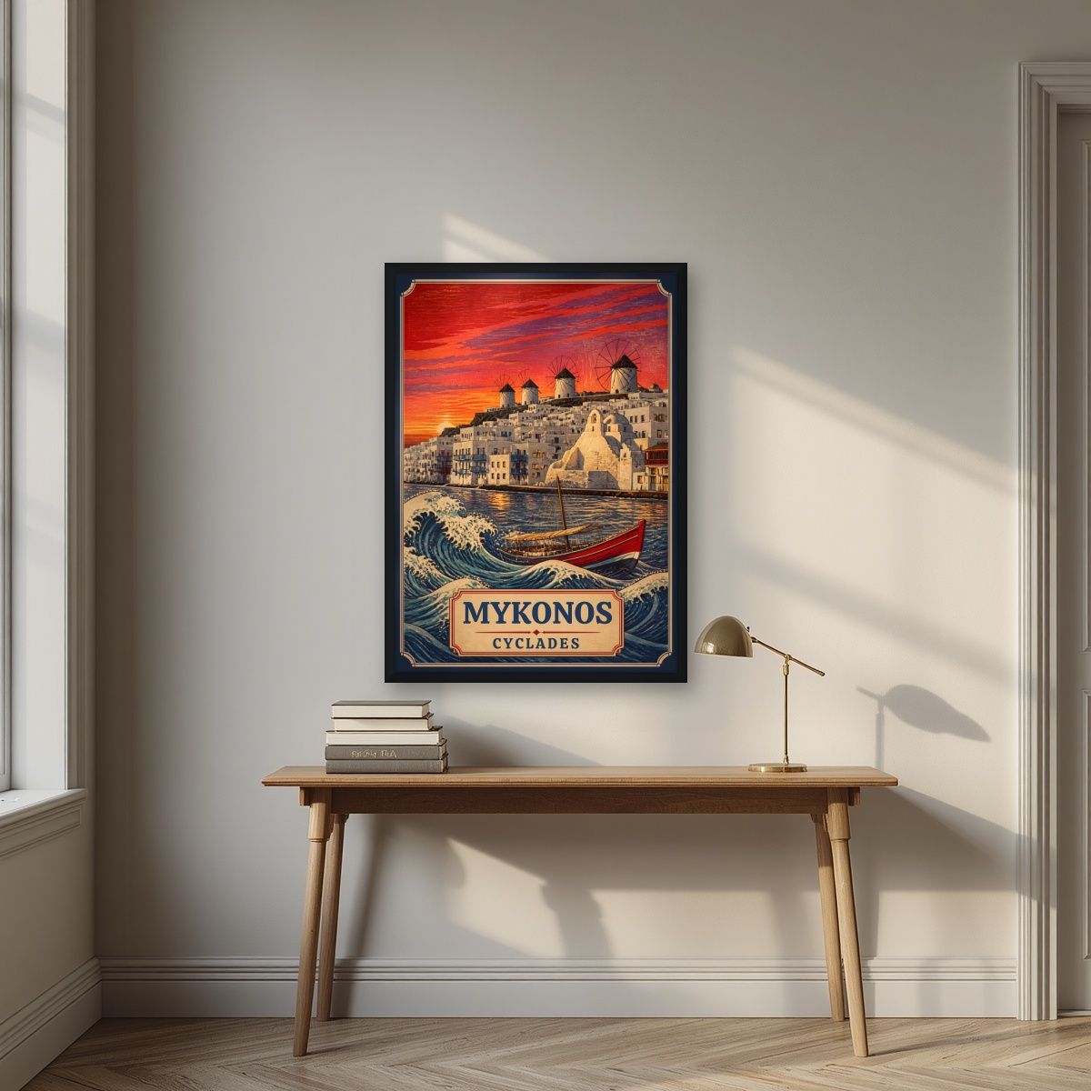 To Kyma — Mykonos art print, in a black frame, styled in a desk