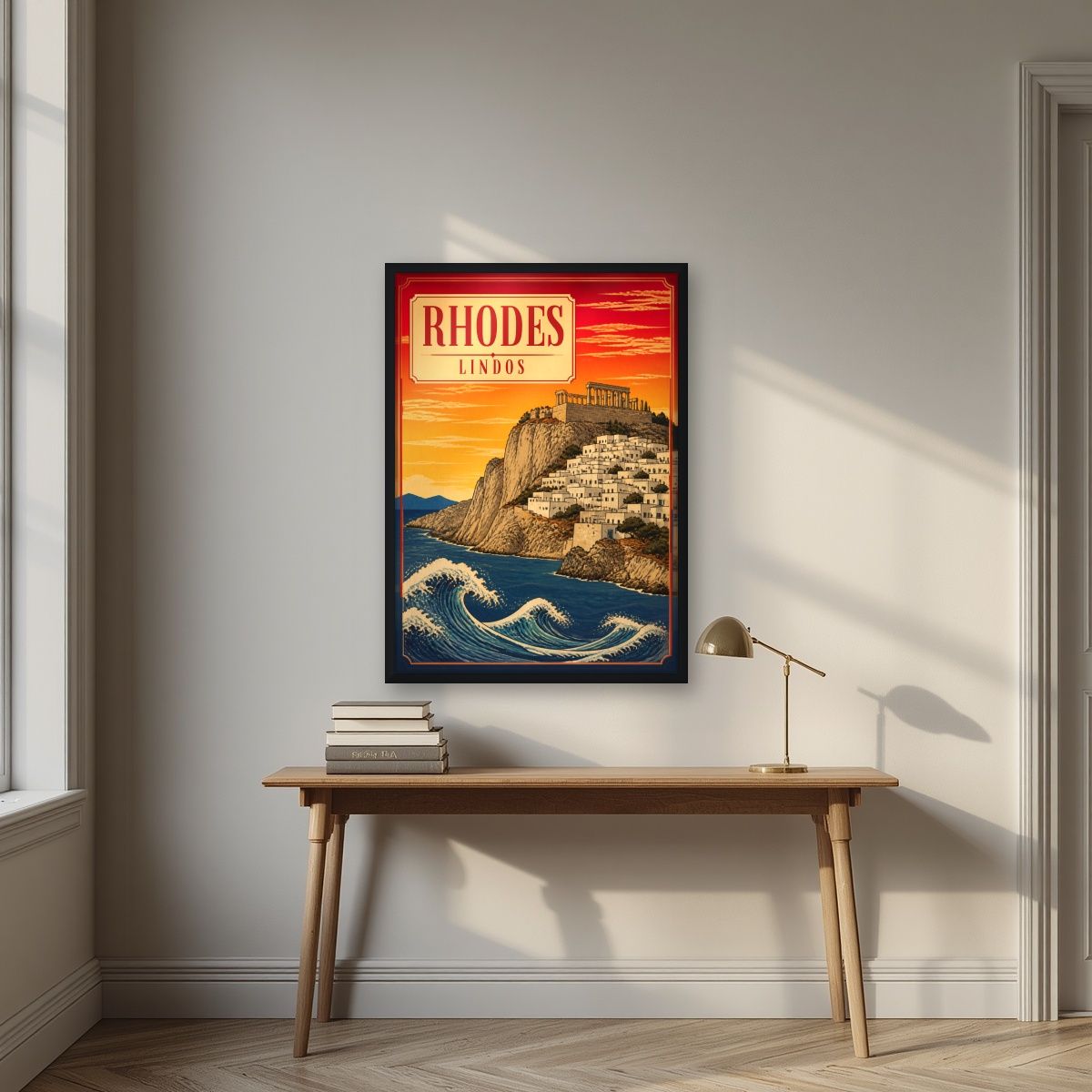 Lindos at Sunset — Rhodes art print, in a black frame, styled in a desk