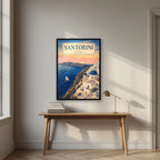 Aegean Dawn — Santorini art print, in a black frame, styled in a desk