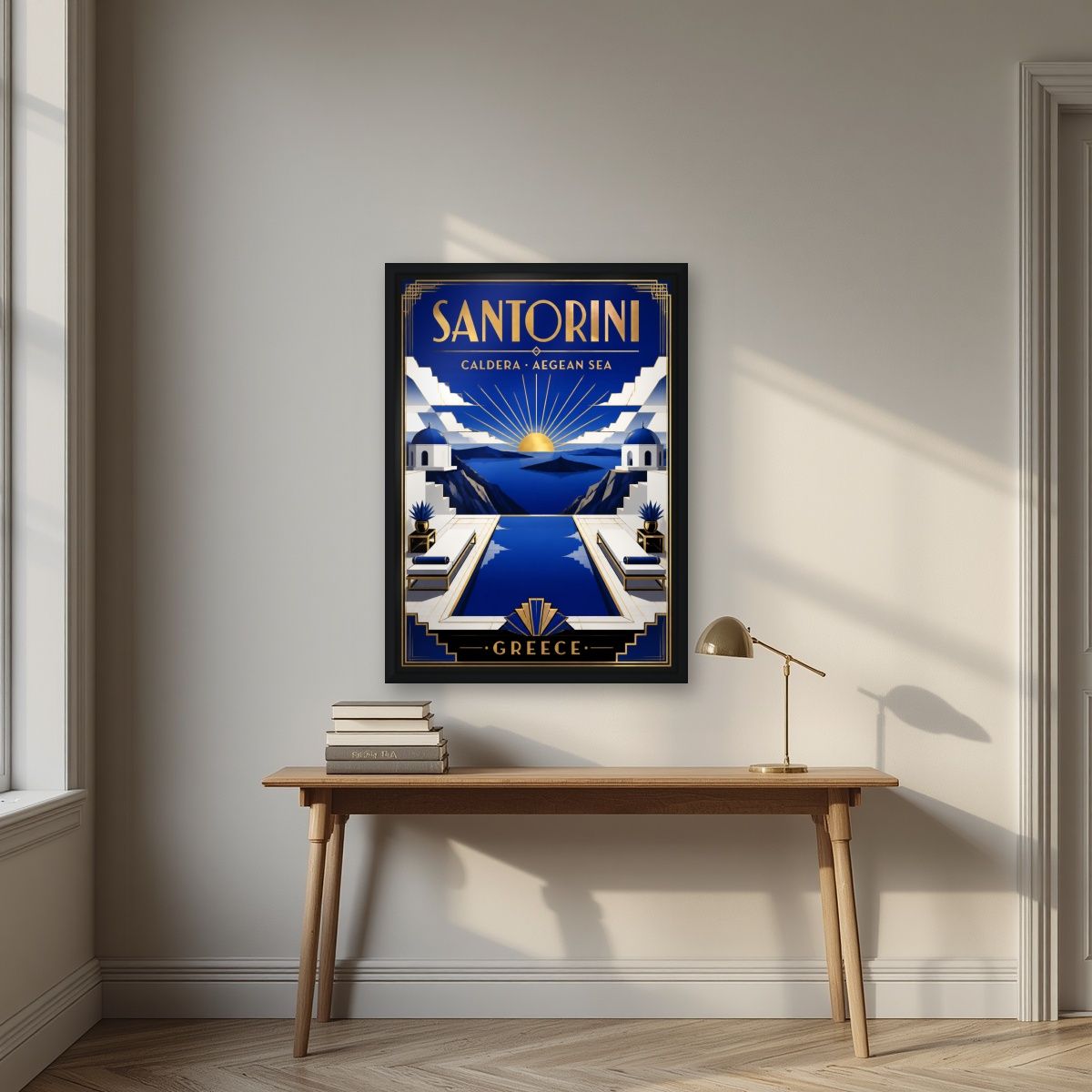 Deco Caldera — Santorini art print, in a black frame, styled in a desk