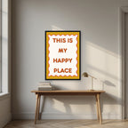 This Is My Happy Place – Ochre art print, in a black frame, styled in a desk