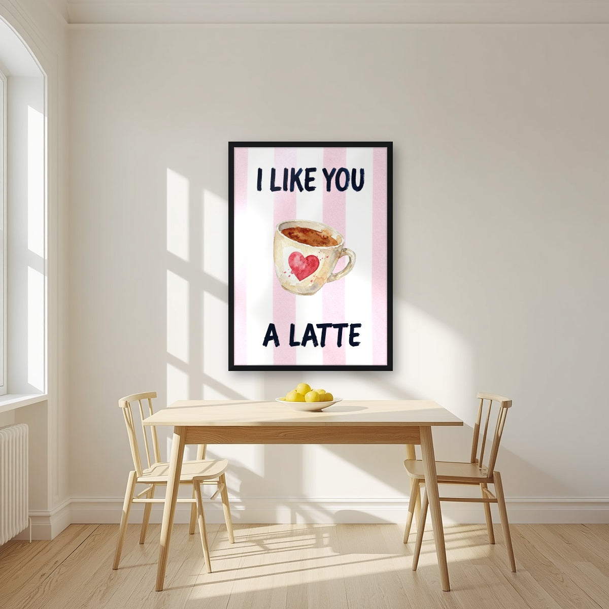 I Like You a Latte – Positano Pink in a black frame, above a dining table in a bright kitchen