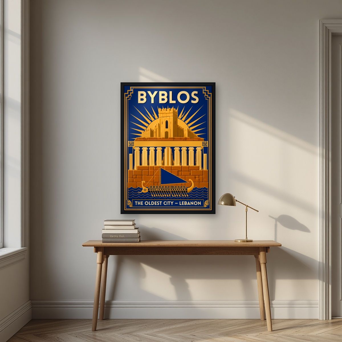 Phoenician Sail — Byblos art print, in a black frame, styled in a desk