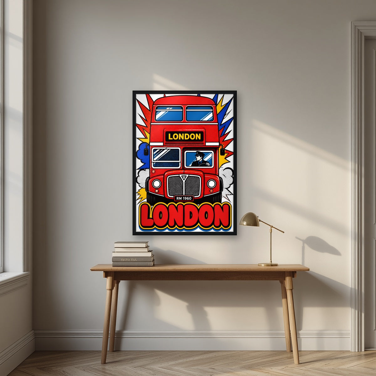 Routemaster London art print in a black frame, above an oak writing desk
